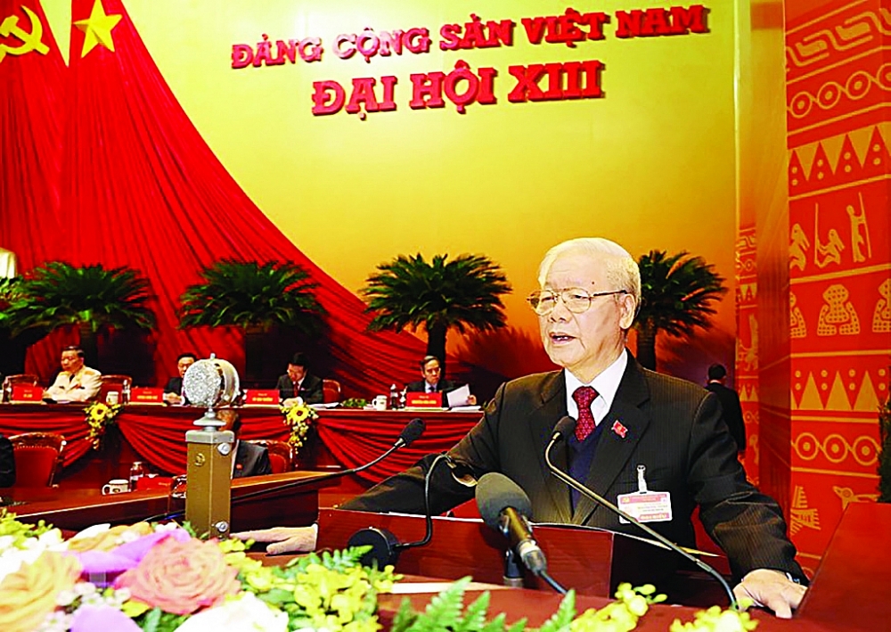 Tổng Bí thư, Chủ tịch nước Nguyễn Phú Trọng đọc báo cáo chính trị của Ban Chấp hành TƯ Đảng khóa XII và các văn kiện trình Đại hội.	Ảnh: TTXVN