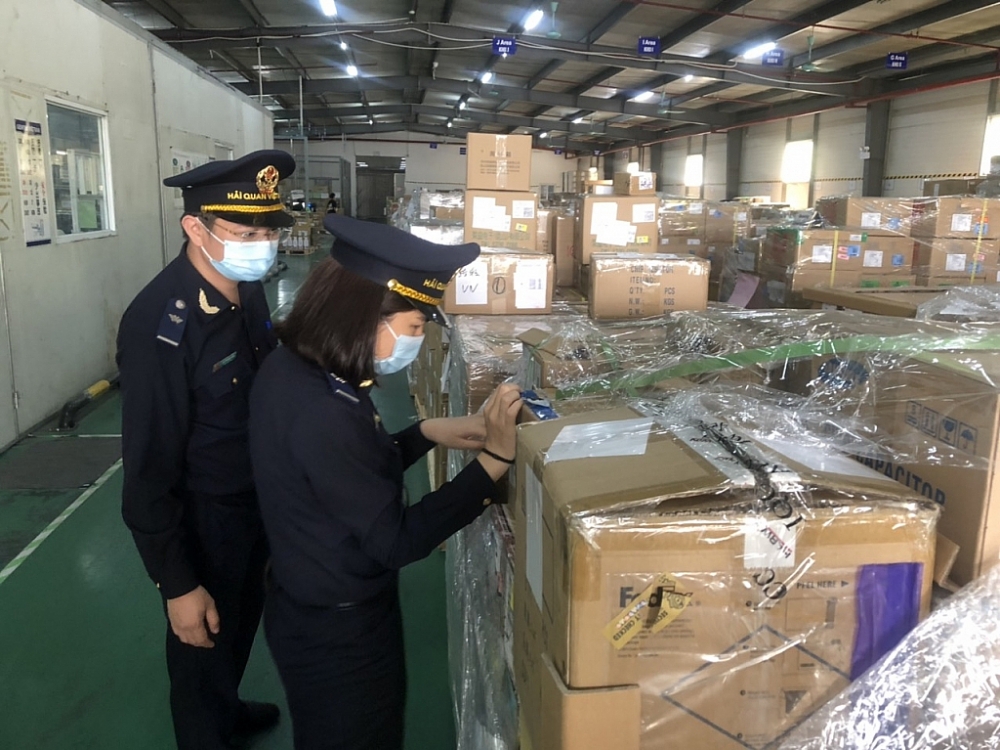 Công chức Hải quan Hà Nam kiểm tra hàng hóa tại trụ sở DN. Ảnh: H.Nụ
