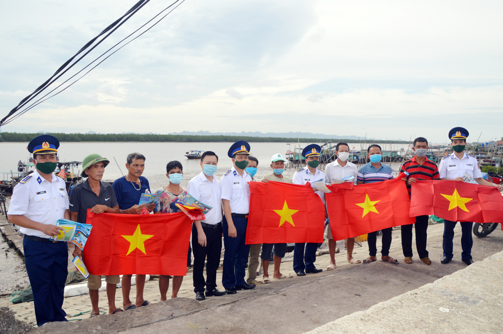 Đoàn công tác tặng cờ Tổ quốc cho bà con ngư dân xã Liên Hòa, thị xã Quảng Yên. 